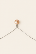 Peach Blossom 12mm golden peach pearl pendant on light beige