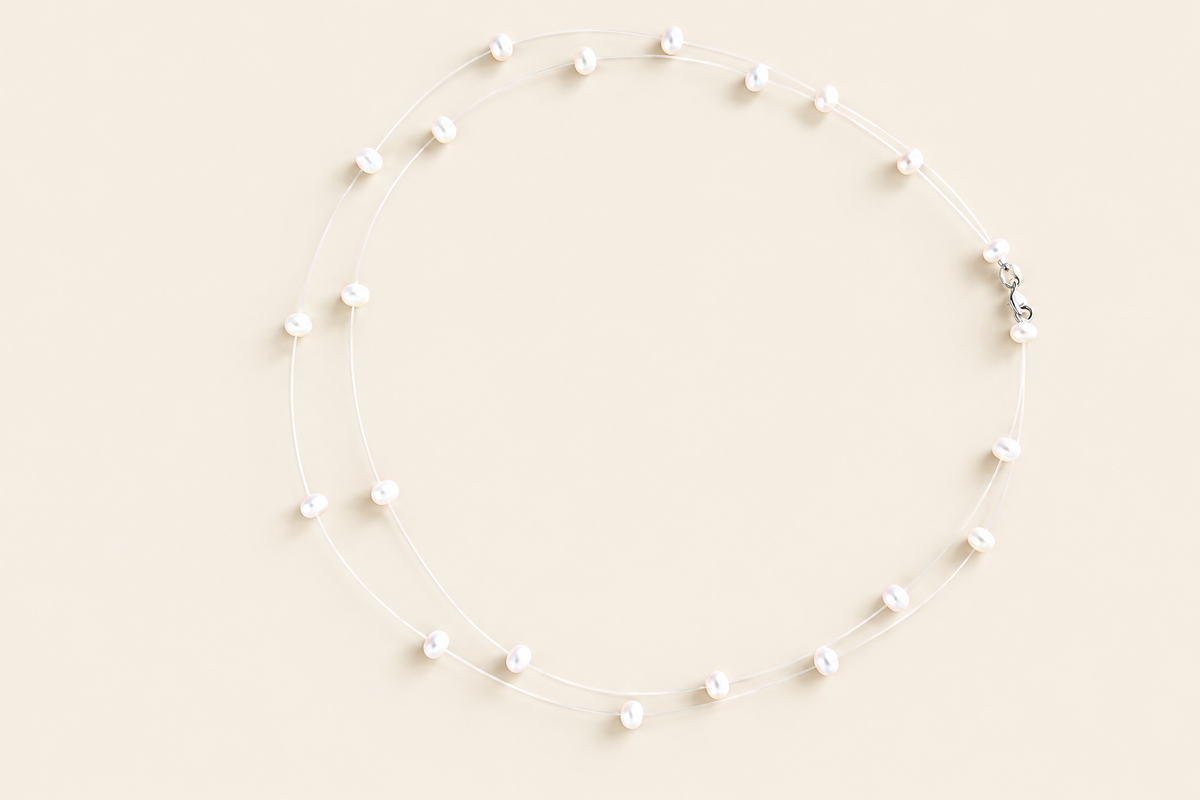 Tears from Heaven floating white freshwater pearl necklace on light beige