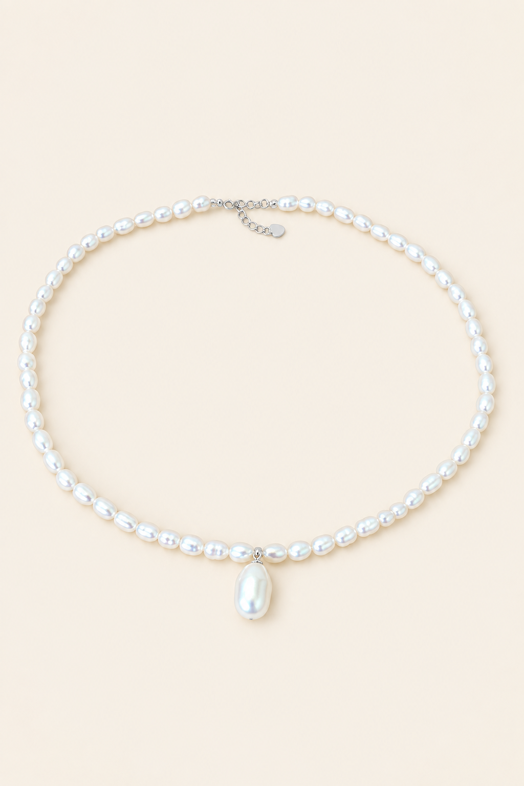 Moon Drop white pearl necklace with drop pearl on light beige